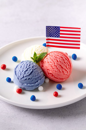 Patriotic colors ice cream scoops with American flag on white plateの写真素材