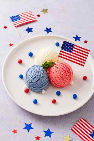 Patriotic colors ice cream scoops with American flag on white plateの写真素材