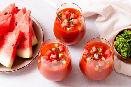 Spanish tomato and watermelon gazpacho cold soup styled and decorated in glassesの写真素材
