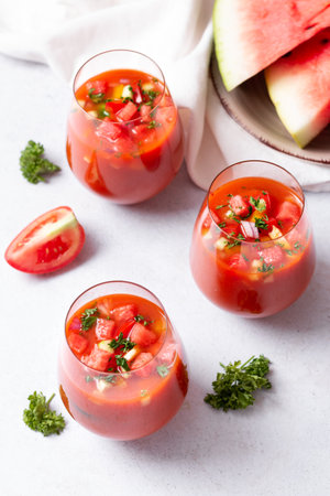 Spanish tomato and watermelon gazpacho cold soup styled and decorated in glassesの写真素材