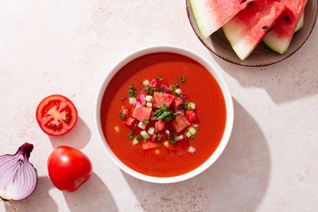 Spanish tomato and watermelon gazpacho cold soup styled and decorated in white plateの写真素材
