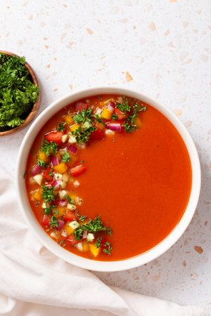 Spanish tomato gazpacho cold soup styled and decorated in white plateの写真素材