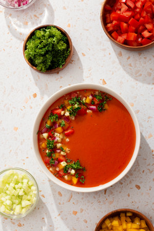 Spanish tomato gazpacho cold soup styled and decorated in white plateの写真素材