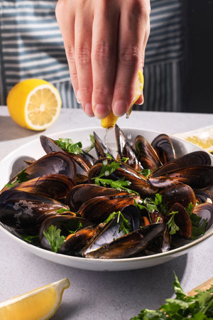 Steam cooked mussels with Vinaigrette garnish on beige plate, top view, Mediterranean cuisine.の写真素材