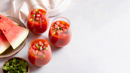 Spanish tomato and watermelon gazpacho cold soup styled and decorated in glassesの写真素材
