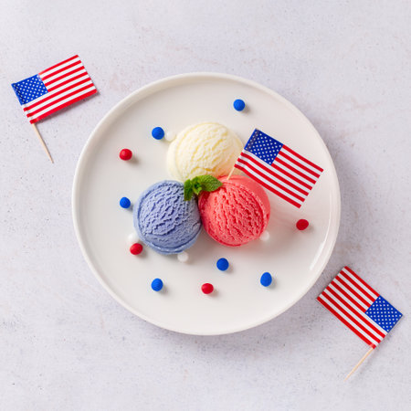 Patriotic colors ice cream scoops with American flag on white plateの写真素材