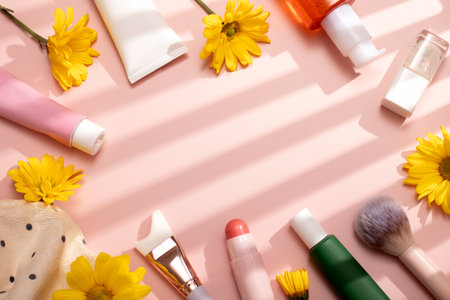 Beauty products frame flat lay with moisturizer, cleansing oil, lotion and makeup items on pastel pink background filled with shadows, spring skincare concept, copy spaceの写真素材