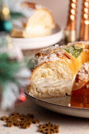 Spanish Three kings cake on decorated table with Christmas tree and burning candles, celebration of Three Kings Dayの写真素材