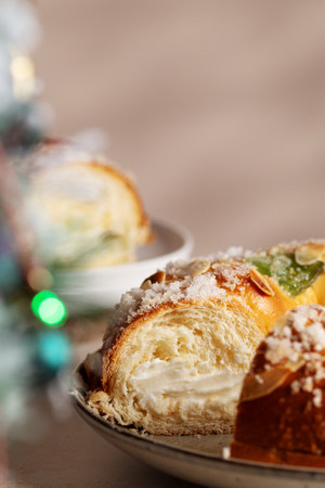 Spanish Three kings cake on decorated table with Christmas tree and burning candles, celebration of Three Kings Dayの写真素材