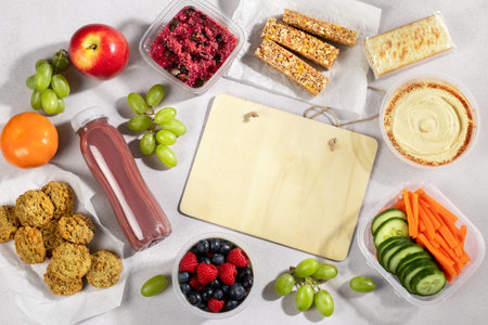 Ready to eat supermarket meal with board for text. Quick food for lunch break, ready vegan meals, flat lay, copy spaceの写真素材