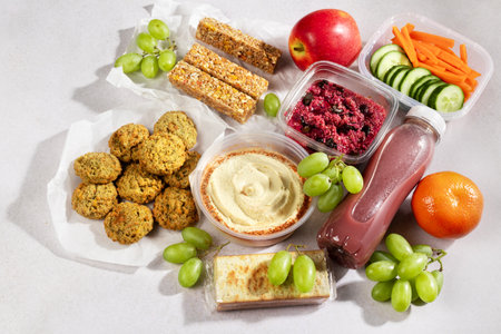 Ready prepared vegan meal with quinoa salad, falafel and fresh smoothies. Quick vegan food to eat on the go or for lunch break, time saving ready to eat healthy meals without animal proteinの写真素材