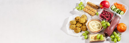 Ready prepared vegan meal with quinoa salad, falafel and fresh smoothies. Quick vegan food to eat on the go or for lunch break, time saving ready to eat healthy meals without animal protein, web bannerの写真素材