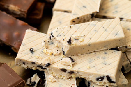 Christmas Spanish holiday treats, chocolate turron with whole almonds, creamy nougat, and polvoronesの写真素材