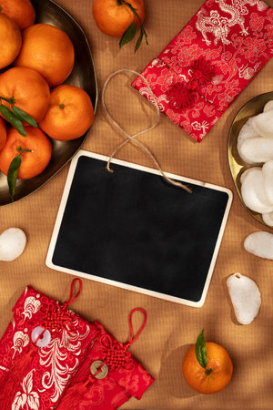 A plate of oranges and red gift envelopes with frame for text, Chinese New Yearの写真素材