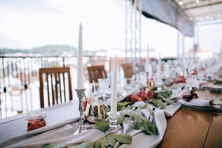 Set tables for wedding dinner on the roof of the houseの写真素材