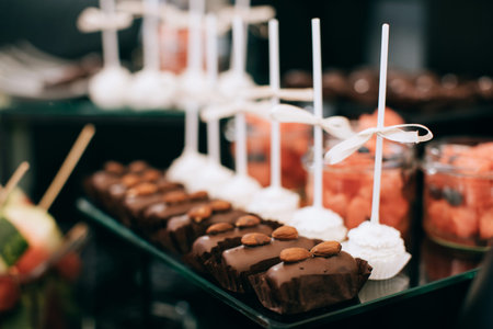 Luxury cakes on wedding dessert table in restaurant on the black backgroundの写真素材