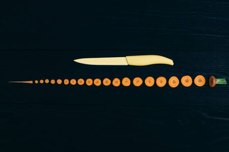 young carrots isolated on black background, cooking fresh vegetables conceptの写真素材