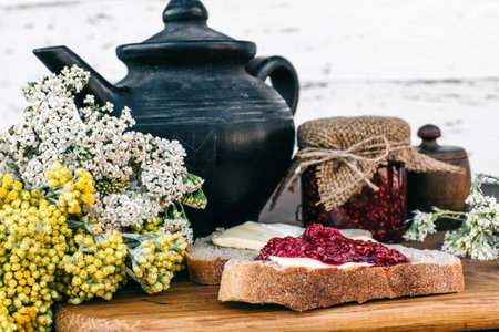 Delicious Provence breakfast with tea and jam on wooden background