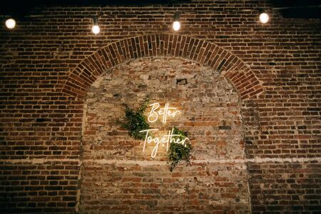 Better Together - neon sign on a brick wall in a restaurant at a wedding party. Love conceptの写真素材