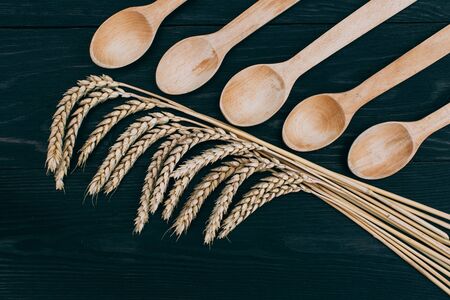 Spikelets of ripe wheat on wooden background. Healthy foodの写真素材