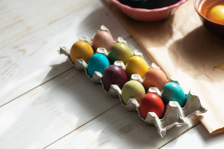 Preparation for Easter. Naturally dyed Easter eggs in egg carton on kitchen