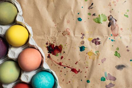 Colorful watercolor background with drops of paint on paper and Easter eggsの写真素材