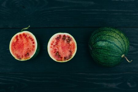 Sliced ââlittle fresh watermelon on a dark background. Summer fruitの写真素材
