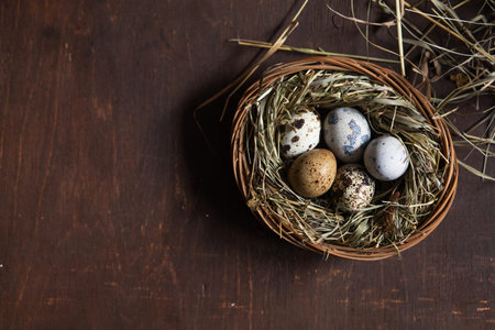 Happy Easter! Easter eggs in nest on wooden table