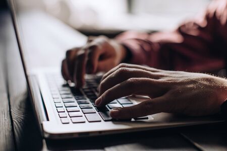 Man hands typing on laptop keyboardの写真素材