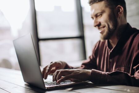 Young man working at laptop in officeの写真素材