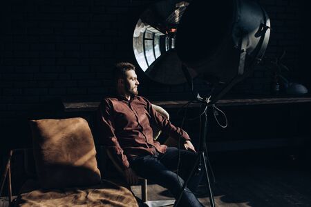 Original portrait of a young bearded man in his workshopの写真素材
