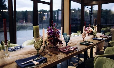 Wedding table with fresh flowers and colorful glasses and napkinsの写真素材