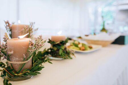 wedding table setting and decoration with candles and fresh flowers	の写真素材