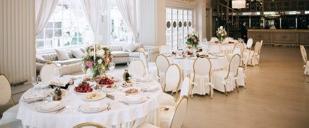 Elegant wedding reception white table arrangement, decoration with flowers and candles