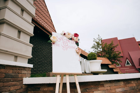 Wedding board. Hand Made Wedding Decoration, flowers, board. Gorgeous white restaurant for the wedding celebrationの写真素材