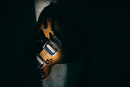 Gold wedding rings lie on an electric guitar. Wedding accessoriesの写真素材