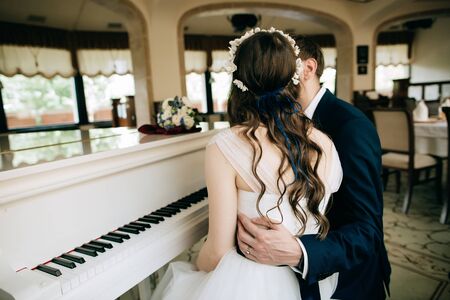 The bride and groom play the piano. Wedding traditionsの写真素材
