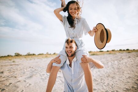 Loving happy young couple walking on the beach. Summer vacationの写真素材