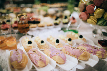 wedding reception, candy bar, dessert table with delicious cakes and cookies