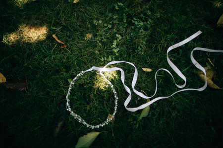 wedding wreath for the bride on the green grass	の写真素材