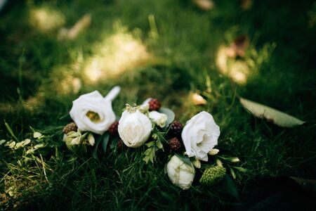 wedding boutonniere for the groom and bridesmaids on the grassの写真素材