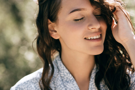 Young happy woman closed her eyes and smiles