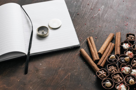 Work and relax space. chocolate candies and a Notepad and compass	