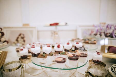 Dessert table with sweets at a wedding ceremony in a restaurantの写真素材