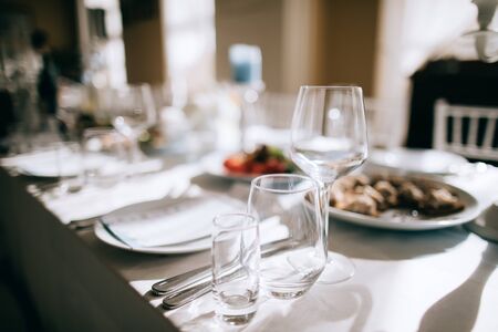 table set for dinner in restaurant with foodの写真素材
