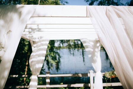 Wedding ceremony arch on the shore of the lake	の写真素材