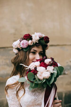 Beautiful bride portrait outdoors in old city. Wedding concept	の写真素材