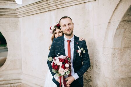 bride and groom celebrating their marriage on the old city in Europe. wedding concept	の写真素材