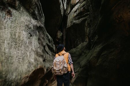 A young man geologist explores a mountain cave, travel conceptの写真素材