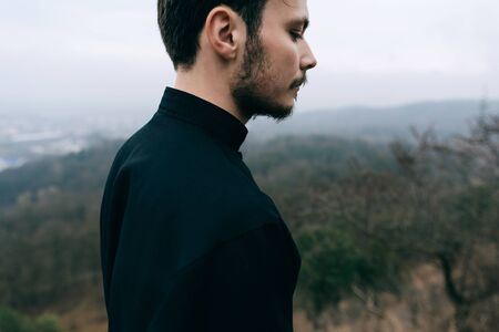 Portrait of a young priest, father with a beard and mustache. Religion Christianity and Catholicismの写真素材